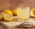 lemons cut with a glass of fresh lemonade