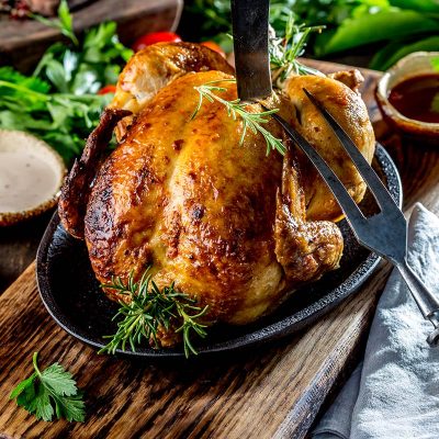 roasted-chicken-with-rosemary-and-sauces-on-wooden-KUGL84J